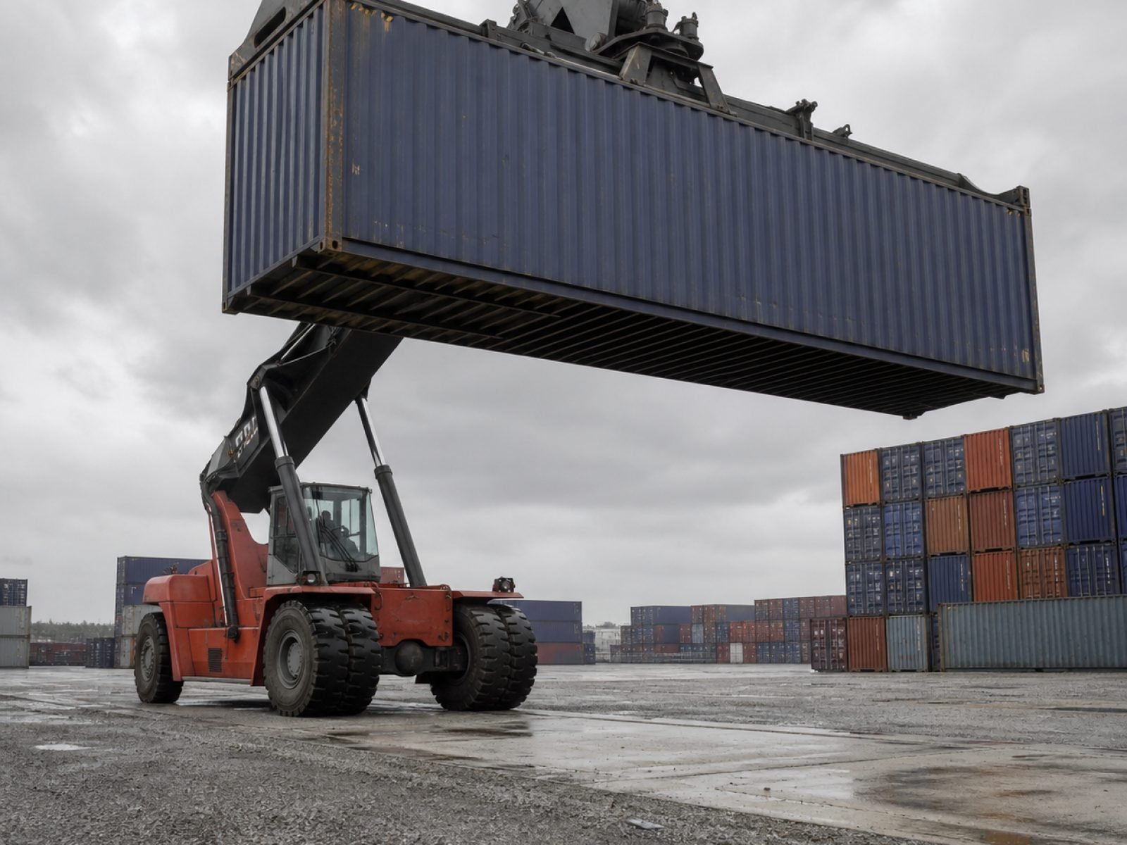 The Wildbox Solutions yard, with a reach stacker lifting a 40ft unit